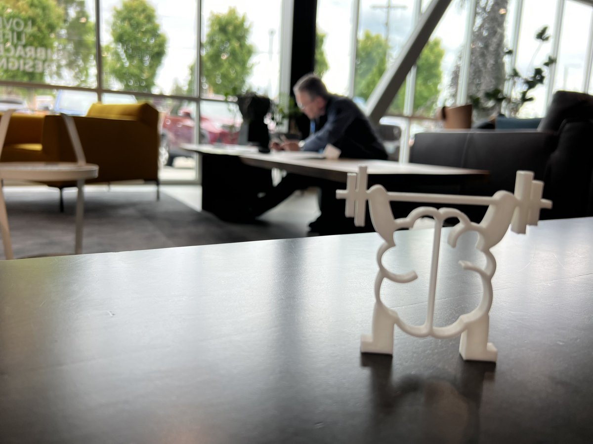 The Kata Together weightlifting brain — a 3D-printed trophy on a table with the dojo space behind it.